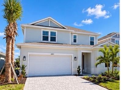Front exterior of the two-story Montauk at 10851 Eclipse Street, Cassia, with palm trees and a paver driveway